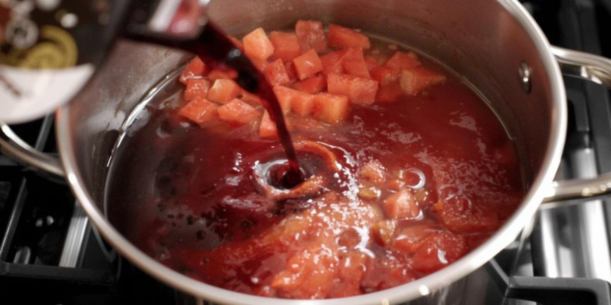 Add the wine and tomatoes.